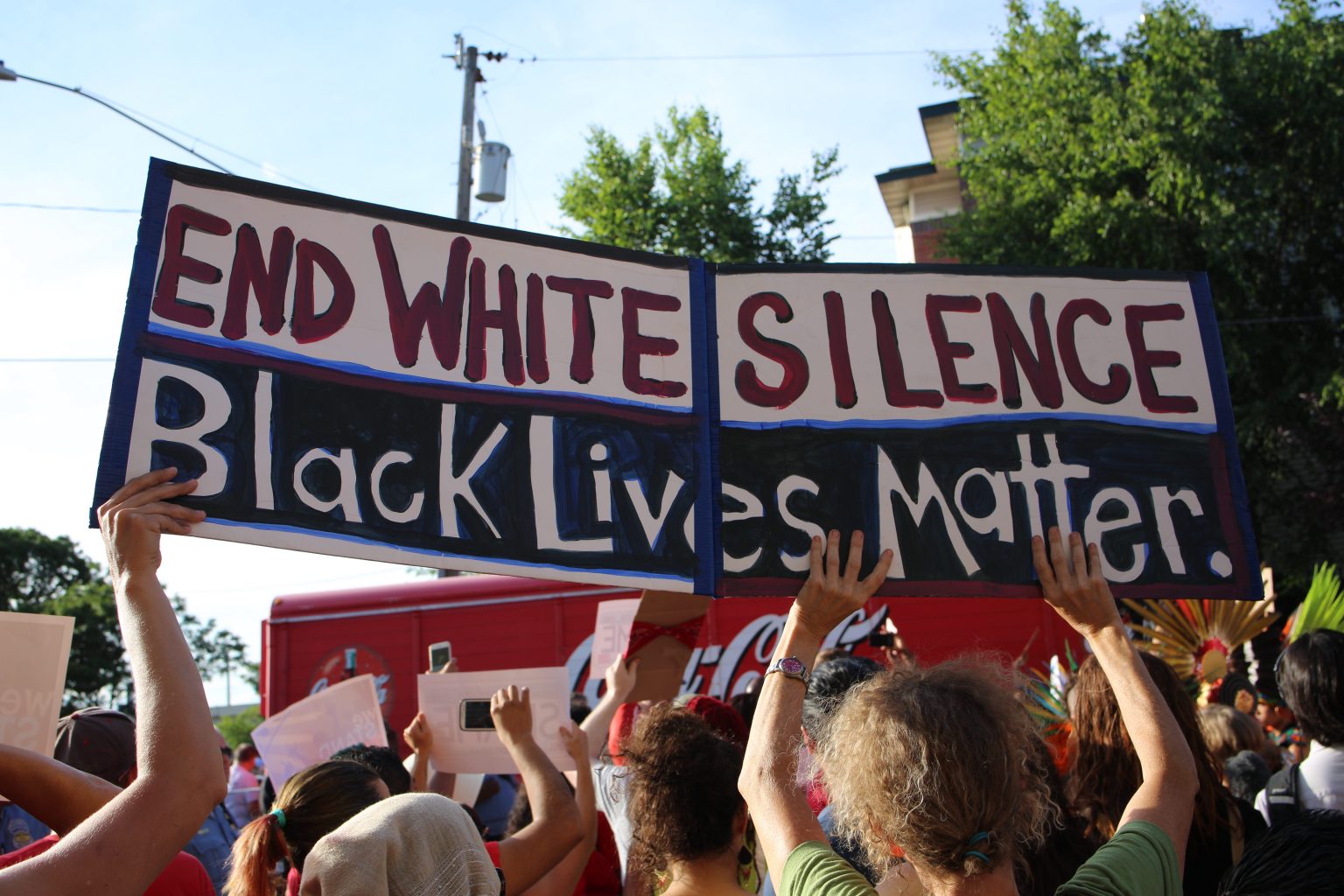 A sign reading 'End White Silence. Black Lives Matter'